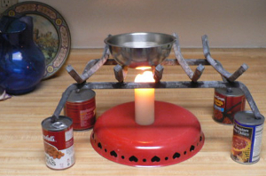canned goods worked to raise the fireplace grate above the candle