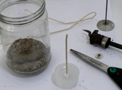 Wick has been inserted into the space left by the wick pin, and is ready for placing in the candle jar